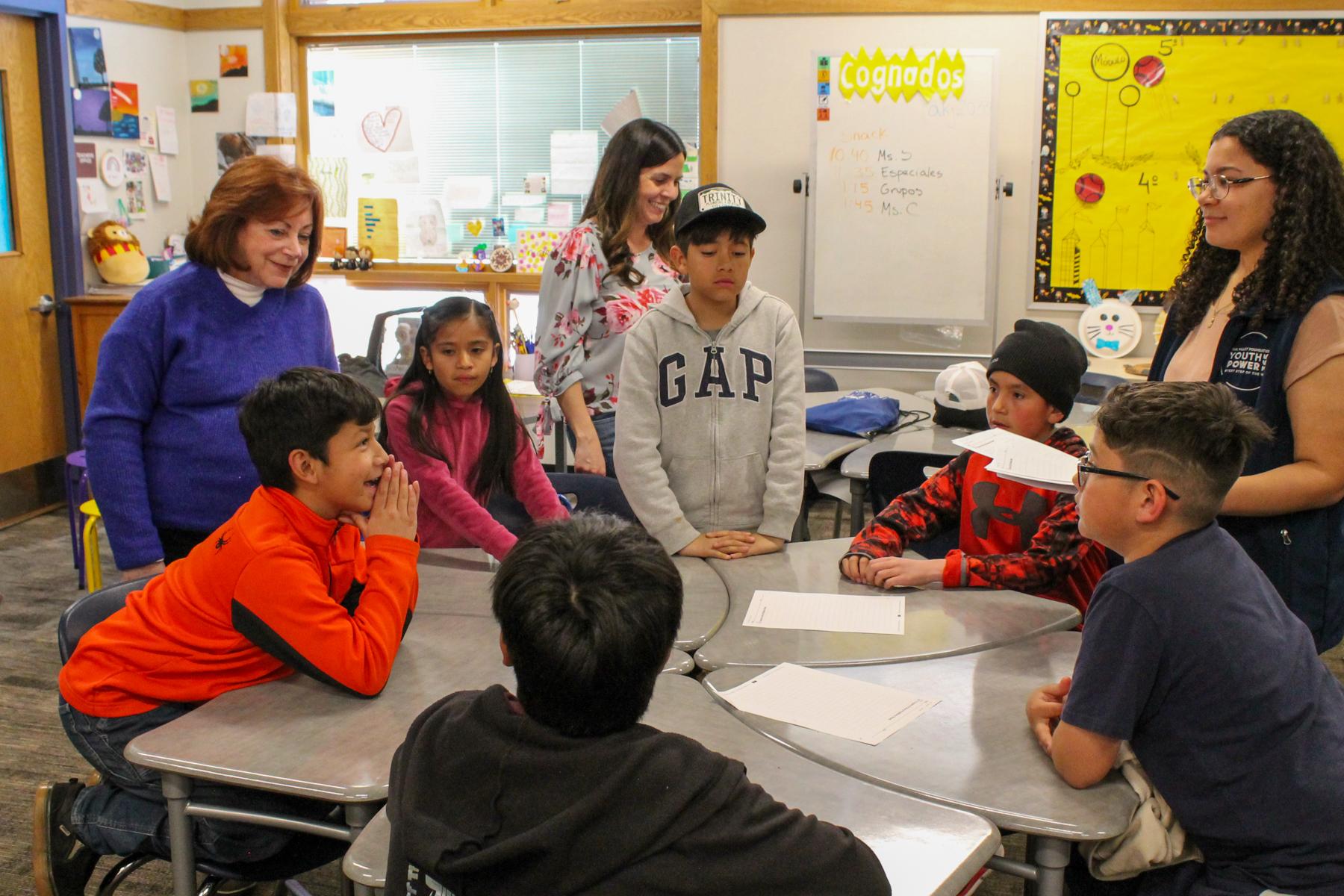 Lt. Governor Dianne Primavera visits Edwards Elementary School and leans in to speak with a table of students