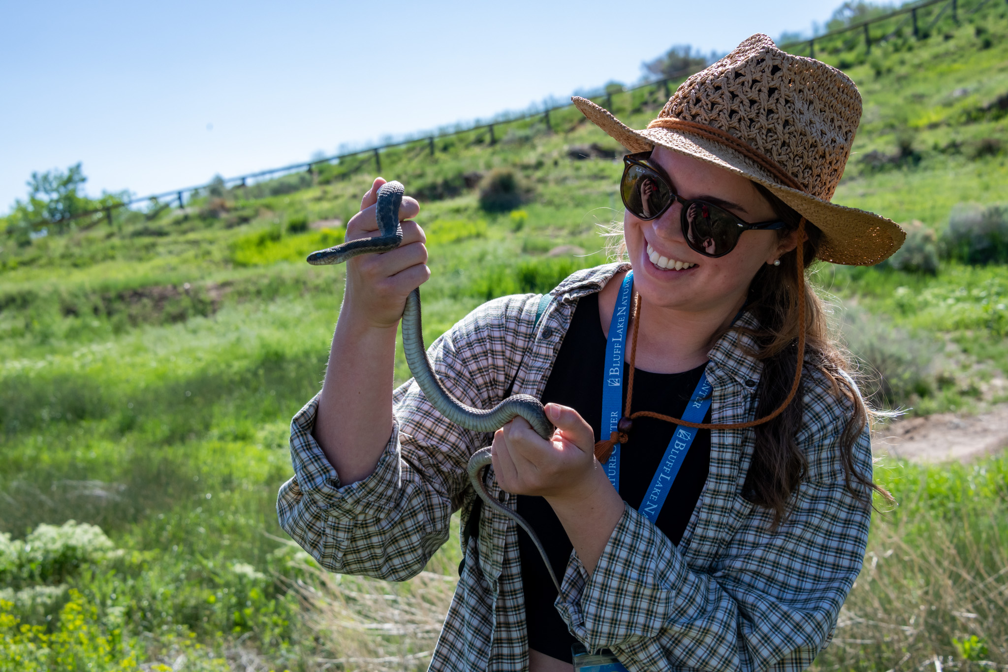 a member holds up a snake