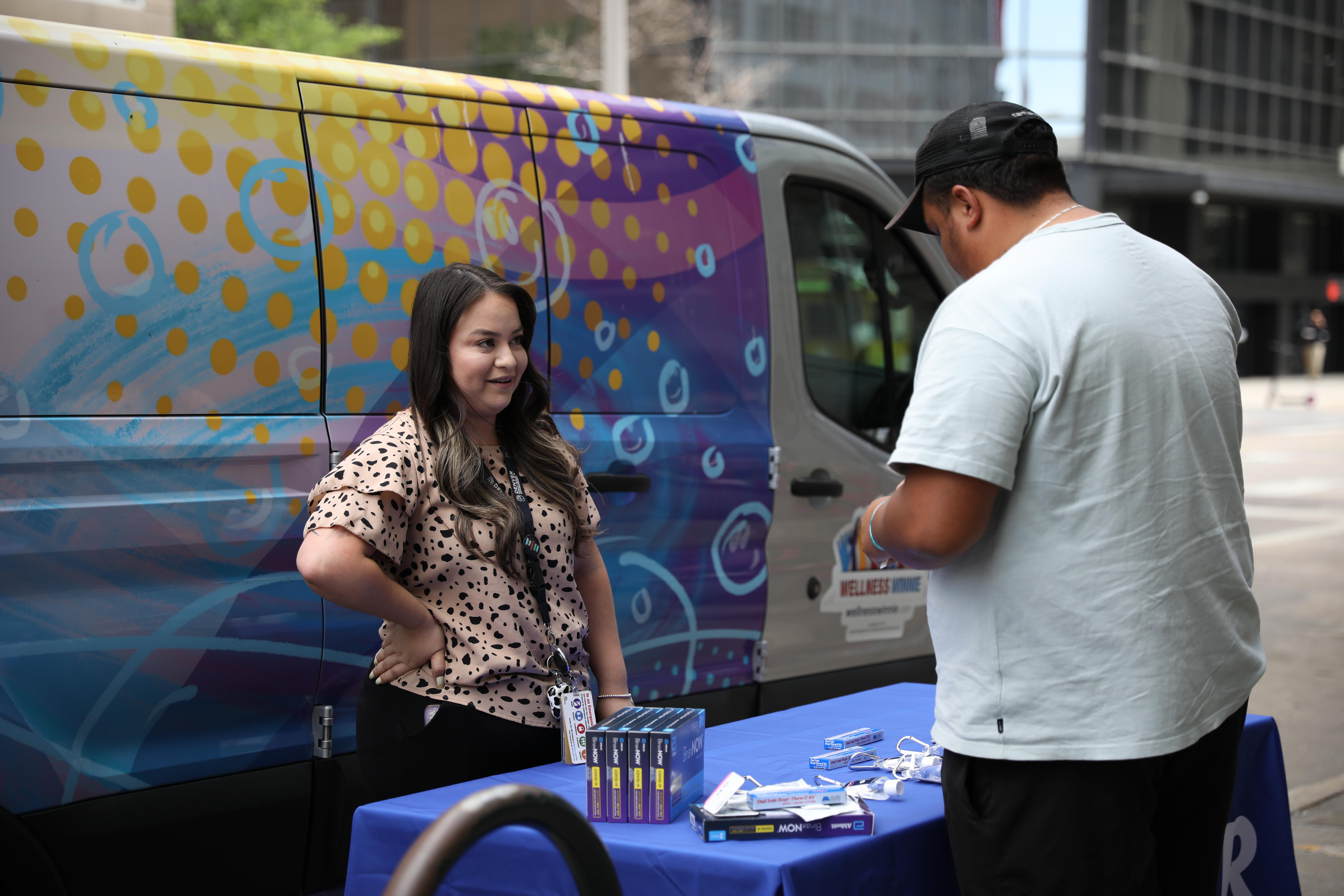 PHA AmeriCorps Members hands out COVID test kits