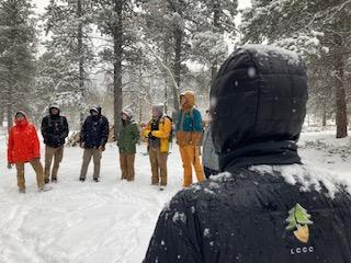AmeriCorps members on a conservation crew standing in the snow